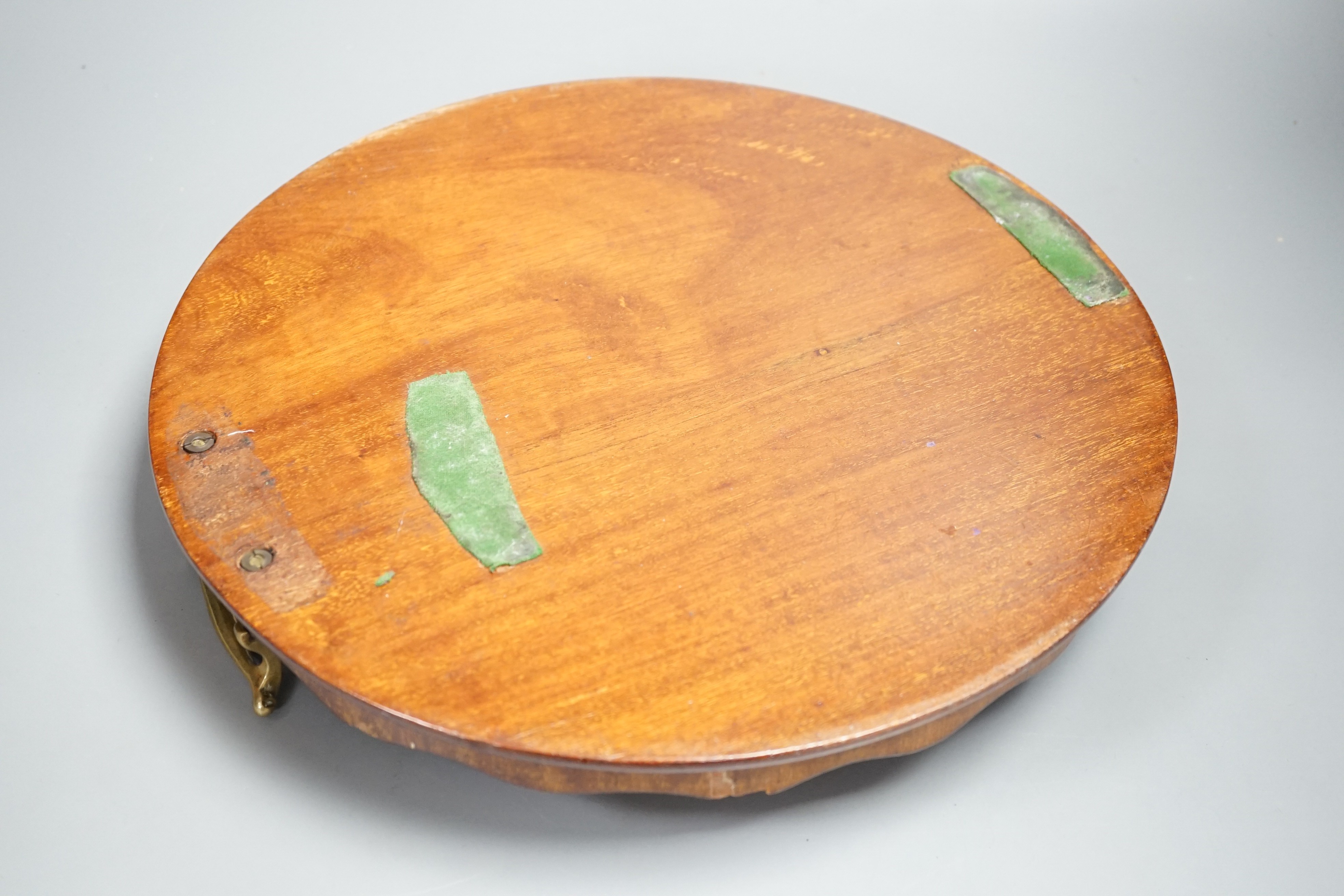 A circular shell inlaid, pie crust edged, brass handled, mahogany tray, 34.5 cms diameter
